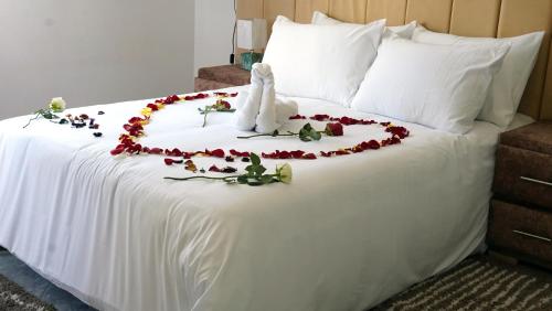 a white bed with a flower arrangement on it at Appartement lux dakhla in Dakhla