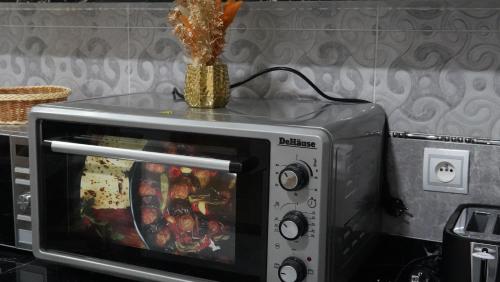 a microwave with a vase on top of it at Appartement lux dakhla in Dakhla