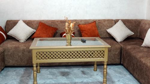 a living room with a couch with a table at Appartement lux dakhla in Dakhla
