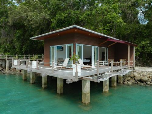 a house on a dock in the water at The Hawk's Nest Resort in Sabong