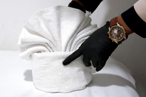 a person holding a roll of toilet paper with a watch at Hébergement lux dakhla in Dakhla