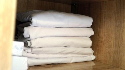 a stack of white towels in a closet at Hébergement lux dakhla in Dakhla