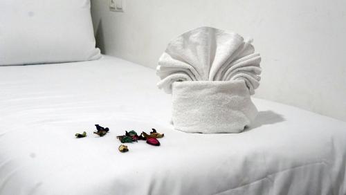 a bed with a towel and some figurines on it at Hébergement lux dakhla in Dakhla