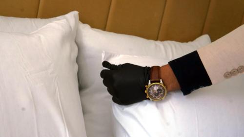 a person with a watch on a bed at Hébergement lux dakhla in Dakhla
