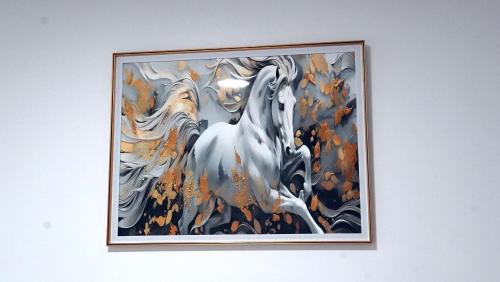 a painting of a white horse on a wall at Hébergement lux dakhla in Dakhla