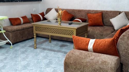 a living room with a couch and a coffee table at Hébergement lux dakhla in Dakhla