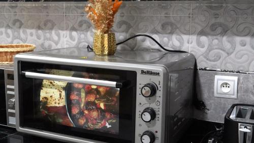a microwave with a vase on top of it at Hébergement lux dakhla in Dakhla