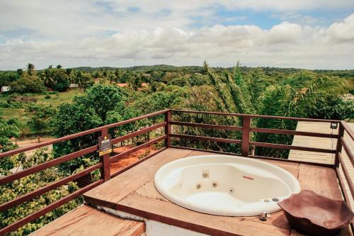 a bath tub sitting on top of a wooden deck at Pipa Panorama Aparthotel in Pipa