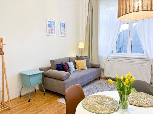 a living room with a couch and a table at Plan A in Budapest