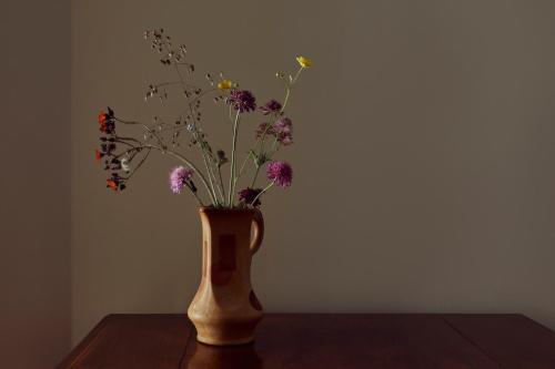 a vase with flowers in it sitting on a table at Boath House Hotel in Nairn