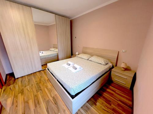 a small bedroom with a bed and a mirror at Dascio Lake Garden Serenity in Dascio
