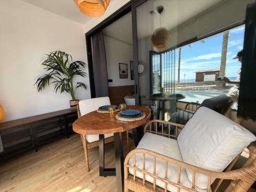 a living room with a table and chairs at Victoria loft in Castell de Ferro