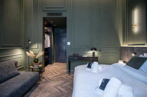 a hotel room with two beds and a couch at Gagos Suites - Center in Larisa