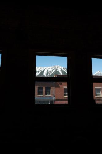 a view of a snow covered mountain from a window at Downtown Loft with Rooftop Hot Tub by StayIn in Fernie