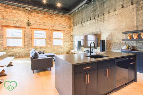 a kitchen with a sink and a counter at Downtown Loft with Rooftop Hot Tub by StayIn in Fernie