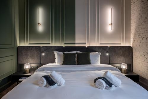 a large white bed with two pillows on it at Gagos Suites - Center in Larisa