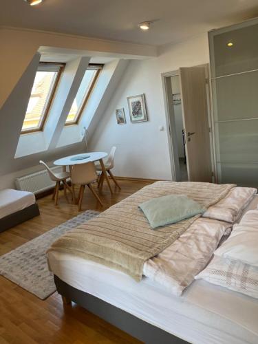 a bedroom with a large bed and a table at Residence Sarka in Prague