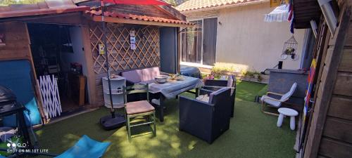 a backyard with a patio with a table and chairs at Petite maison 45 m2 avec terrasse sans vis à vis in Le Castellet