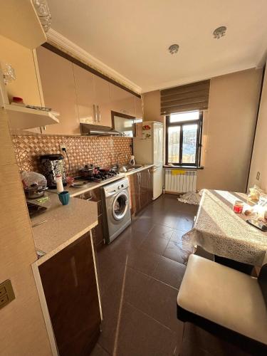 a kitchen with a stove and a dishwasher at Ideal apartments for family in Ganja