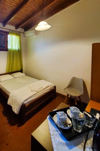 a bedroom with a bed and a tray of food on a table at Diporto in Chania Town