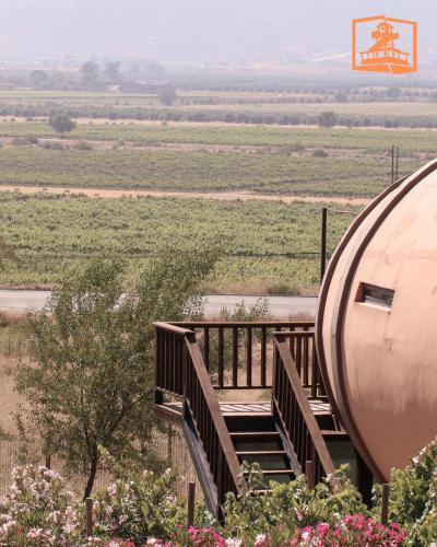a stairway leading to a round building with a field at Finca el Mirador in Valle de Guadalupe