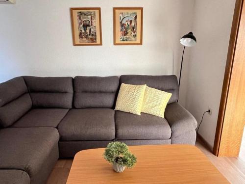 a living room with a couch and a table at Villa Naledi in Pašman