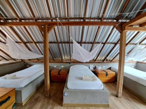 a room with two beds and a roof at REFUGIO LA ROCA in Los Santos