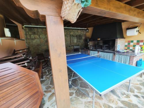 a ping pong table in the middle of a room at Posada el Remanso de Trivieco in La Cavada