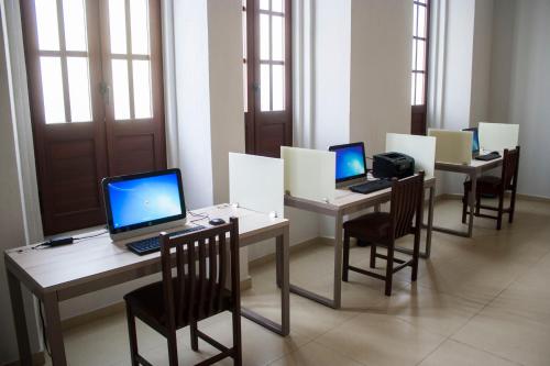 a row of desks with laptops on them at Hotel Casino Plaza in Guadalajara