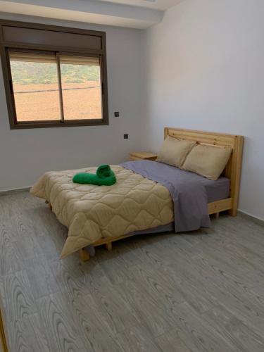 a bedroom with a bed and a window at Nomad Surf Lodge in Imsouane