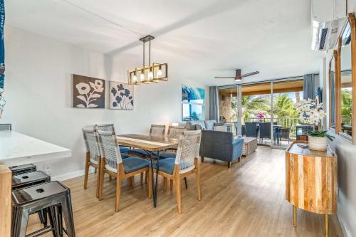 a kitchen and dining room with a table and chairs at Oceanfront Modern & Elegant Vistas in Kihei