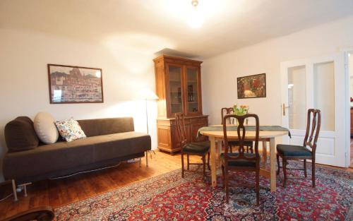 a living room with a couch and a table at Ferienwohnungen Villa Winkler in Velden am Wörthersee