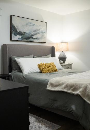 a bedroom with a large bed with a yellow pillow on it at Little Gem in Millersburg