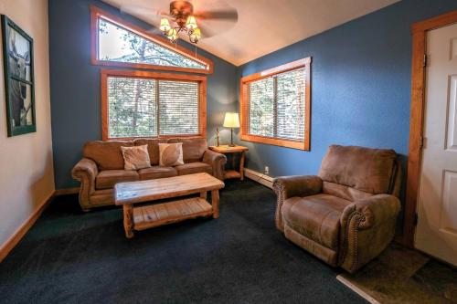 a living room with two chairs and a couch at Timber Creek Chalets- 9 chalet in Estes Park