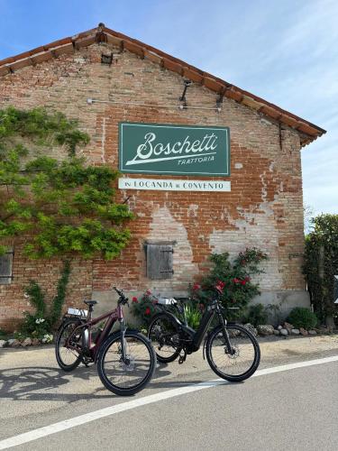 three bikes parked in front of a brick building at Locanda al Convento in Favaro Veneto