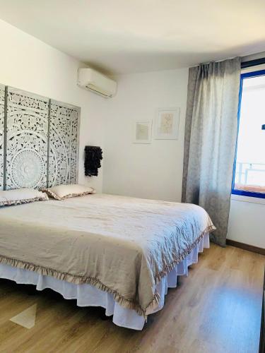 a bedroom with a large bed in a room at Private apartment with stunning ocean views and sunset. in Taurito