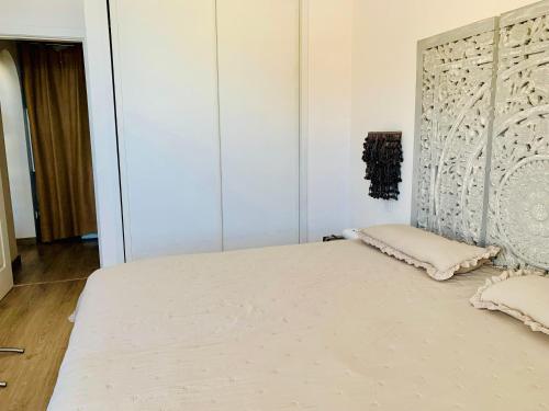 a bedroom with a large bed with white sheets at Private apartment with stunning ocean views and sunset. in Taurito