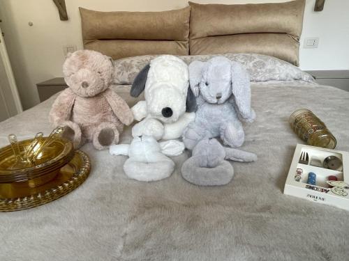 a group of stuffed animals sitting on a bed at La Rosa del Lago in Lenno
