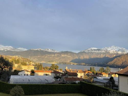 a view of a town with a lake and mountains at La Rosa del Lago in Lenno
