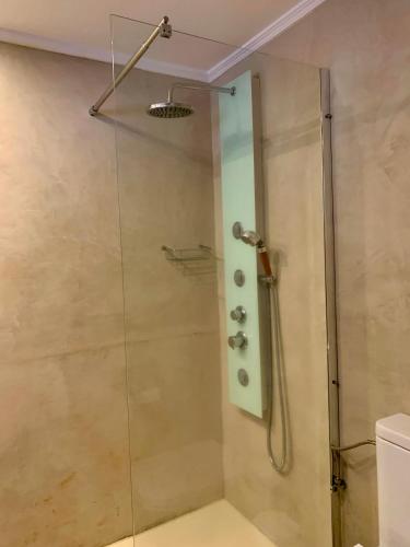 a shower in a bathroom with a glass door at Private apartment with stunning ocean views and sunset. in Taurito
