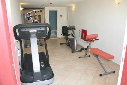 a gym with several exercise equipment in a room at Katerina Hotel in Agios Prokopios