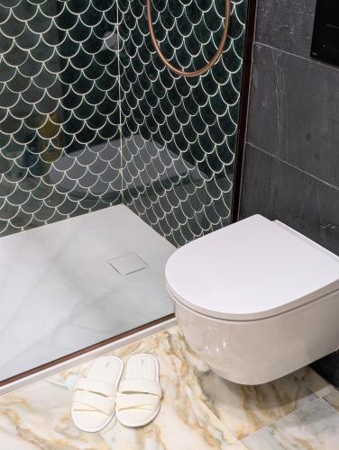 a bathroom with a toilet and two slippers at Płachtówka in Słupia