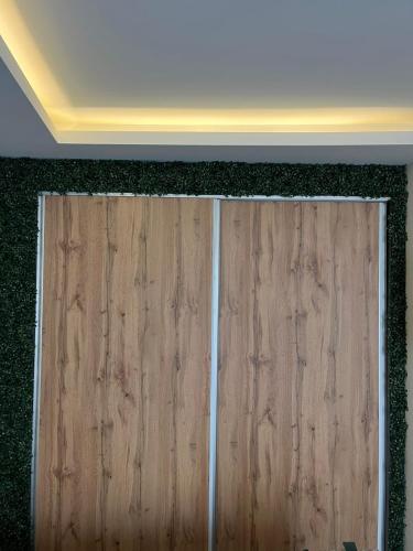a wooden door in a room with a ceiling at FREE PARKING City Square Vanilla Apart-Hotel in Skopje