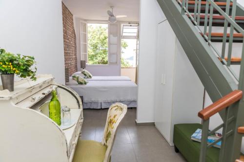 a room with a table and chairs and a bed at Gerthrudes Bed & Breakfast in Rio de Janeiro