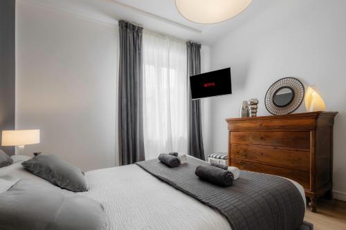 a bedroom with a bed with two stuffed animals on it at Suite Matteotti Luxury & Elegance in Verona