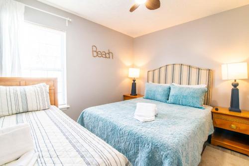 a bedroom with two beds and two lamps in it at Blue Wave Retreat in Heart of Myrtle Beach in Myrtle Beach