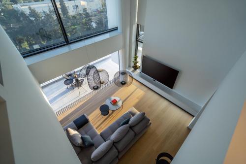 an overhead view of a living room with a couch and a tv at The White Loft - Cretan Luxury in Ierápetra