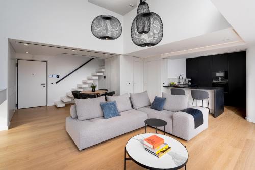 a living room with a couch and a table at The White Loft - Cretan Luxury in Ierápetra