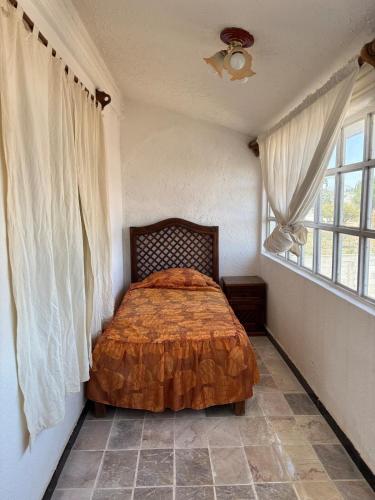 a bedroom with a bed in a room with a window at Casquito de Hacienda in Ezequiel Montes