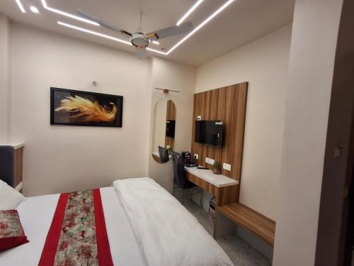 a hotel room with a bed and a sink at Raghav Vilas - Essence of Kashi in Varanasi